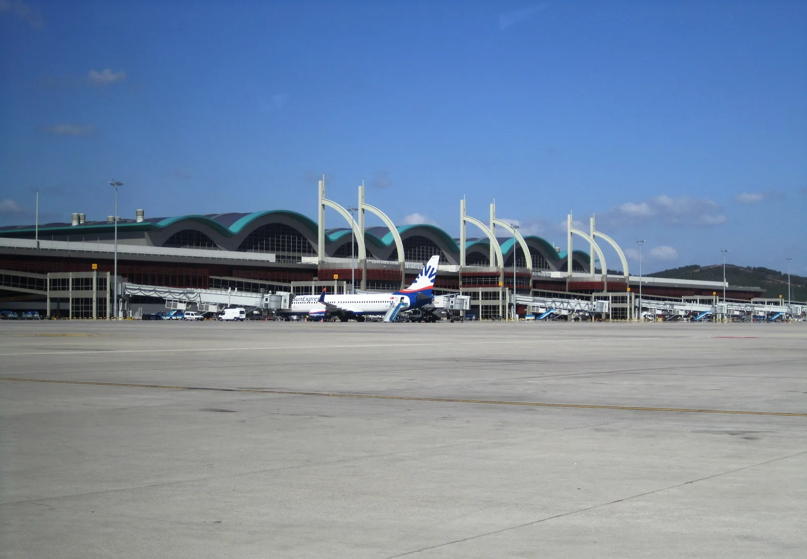 Sabiha Gökçen Airport terminal seen from the apron, with the terminal building and an aircraft.