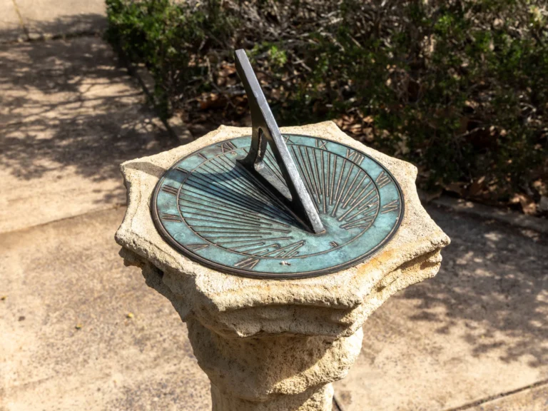 A sunlit sundial casting a shadow, illustrating traditional direction-finding methods.